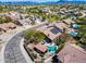 A high aerial view features a house with a private pool and nearby community at 29023 N 48Th Ct, Cave Creek, AZ 85331