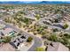 Expansive aerial view of a desert community featuring homes with pools, solar panels and desert landscape at 29023 N 48Th Ct, Cave Creek, AZ 85331