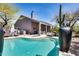 Backyard showcasing a pool, patio, and outdoor kitchen in a desert landscape at 29023 N 48Th Ct, Cave Creek, AZ 85331