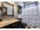 Well-lit bathroom featuring a vanity with a granite countertop and a shower with a stylish curtain at 29023 N 48Th Ct, Cave Creek, AZ 85331