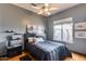 Cozy bedroom with hardwood floors, a ceiling fan, and ample natural light, creating a warm and inviting atmosphere at 29023 N 48Th Ct, Cave Creek, AZ 85331