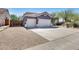Exterior of a two-car garage home with an RV gate and desert landscaping at 29023 N 48Th Ct, Cave Creek, AZ 85331