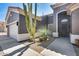 Inviting front entrance features drought-tolerant landscaping, and modern grey exterior at 29023 N 48Th Ct, Cave Creek, AZ 85331