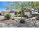 Charming front yard featuring desert landscaping, mature cacti, and a grey home exterior at 29023 N 48Th Ct, Cave Creek, AZ 85331