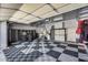 Spacious garage with tiled floor, storage cabinets, and overhead lighting at 29023 N 48Th Ct, Cave Creek, AZ 85331