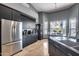 Stylish kitchen with black cabinetry, stainless steel fridge, and adjacent dining area at 29023 N 48Th Ct, Cave Creek, AZ 85331