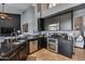 Open kitchen featuring stainless steel appliances, a black island, and modern finishes at 29023 N 48Th Ct, Cave Creek, AZ 85331