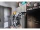 Well-equipped laundry room with washer, dryer, cabinetry, and modern appliances at 29023 N 48Th Ct, Cave Creek, AZ 85331
