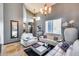 Bright living room featuring elegant white furniture and a decorative chess set at 29023 N 48Th Ct, Cave Creek, AZ 85331