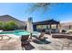 Backyard features a refreshing pool, lounge chairs, and covered patio with a hot tub at 29023 N 48Th Ct, Cave Creek, AZ 85331