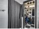 Walk-in closet with shelving, storage, hanging racks, and checkered floors at 29023 N 48Th Ct, Cave Creek, AZ 85331