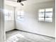 Corner bedroom featuring wood-look tiled floors and bright natural light from multiple windows at 2925 N 19Th Ave # 97, Phoenix, AZ 85015