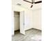 Bedroom with wood-look tiled floors, ceiling fan, and closet with open door at 2925 N 19Th Ave # 97, Phoenix, AZ 85015