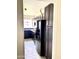 Galley kitchen features dark cabinets, black refrigerator, and view into the sink area at 2925 N 19Th Ave # 97, Phoenix, AZ 85015