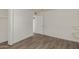 Bright bedroom featuring wood-look flooring, neutral walls, and an open doorway at 3030 W Christy Dr, Phoenix, AZ 85029