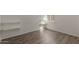 Bright bedroom with wood-look flooring, small window, and built-in shelving at 3030 W Christy Dr, Phoenix, AZ 85029
