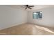 Light-filled bedroom with a ceiling fan, tile flooring, and a large window at 3030 W Christy Dr, Phoenix, AZ 85029