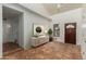 Bright entryway with striking tile floors, clerestory windows, and stylish console with artwork at 3030 W Christy Dr, Phoenix, AZ 85029