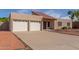 Inviting single-story home features a two-car garage, red tile roof, and low-maintenance desert landscaping at 3030 W Christy Dr, Phoenix, AZ 85029