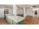 Open concept kitchen with an island featuring a stainless steel refrigerator and terra cotta flooring at 3030 W Christy Dr, Phoenix, AZ 85029