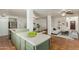 Open-concept kitchen flows into dining and living areas, featuring tiled floor, green cabinets, and stainless appliances at 3030 W Christy Dr, Phoenix, AZ 85029