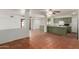 Bright living space with Saltillo tile floors, ceiling fan, and views to kitchen at 3030 W Christy Dr, Phoenix, AZ 85029
