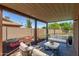 Inviting covered patio features comfortable seating and view of raised garden beds at 3030 W Christy Dr, Phoenix, AZ 85029