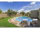 Beautiful backyard oasis featuring a sparkling pool, lounge chairs, and lush landscaping at 3030 W Christy Dr, Phoenix, AZ 85029