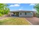 View of backyard featuring partial grass and gravel, a covered patio, and neutral-toned home exterior at 31318 N 26Th Dr, Phoenix, AZ 85085