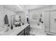 Bright bathroom featuring double sinks, a soaking tub, and a separate glass-enclosed shower at 31318 N 26Th Dr, Phoenix, AZ 85085