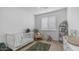 Cozy Bedroom featuring a white crib, neutral rocking chair, plush rug and a changing table for a soothing ambiance at 31318 N 26Th Dr, Phoenix, AZ 85085