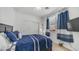 Cozy bedroom with natural light, ceiling fan, and a closet with sliding doors at 31318 N 26Th Dr, Phoenix, AZ 85085