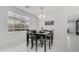 Dining area featuring a modern chandelier, large window and white paint with tile floors at 31318 N 26Th Dr, Phoenix, AZ 85085