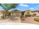 Home with a desert landscape, a mature tree, and a welcoming two car garage at 31318 N 26Th Dr, Phoenix, AZ 85085