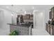 Stylish kitchen boasting a dark island, pendant lighting, and dark cabinets with modern appliances at 31318 N 26Th Dr, Phoenix, AZ 85085