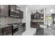 This kitchen boasts stainless steel appliances, sleek dark countertops, and eye-catching decorative backsplash at 31318 N 26Th Dr, Phoenix, AZ 85085