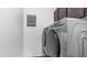 Laundry room with a modern, front-load washer and dryer set and a sign with Gathering rules at 31318 N 26Th Dr, Phoenix, AZ 85085