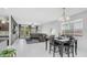 Bright, open concept living area with tile floors, wood accent wall, and a dining area at 31318 N 26Th Dr, Phoenix, AZ 85085