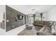 Comfortable living room featuring modern decor, a wood accent wall, and neutral tile floors at 31318 N 26Th Dr, Phoenix, AZ 85085