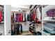 Well-organized walk-in closet with ample shelving and hanging space for clothes and shoes at 31318 N 26Th Dr, Phoenix, AZ 85085