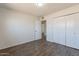Bedroom featuring hardwood floors, spacious closets and a ceiling fan at 3441 W Sweetwater Ave, Phoenix, AZ 85029