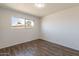 Bedroom with wood flooring and a window providing natural light at 3441 W Sweetwater Ave, Phoenix, AZ 85029