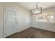 Open dining area featuring hardwood floors, natural light, and a stylish light fixture at 3441 W Sweetwater Ave, Phoenix, AZ 85029