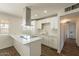 Beautiful kitchen features new stainless appliances, quartz countertops, and a stylish range hood and hardwood floors at 3441 W Sweetwater Ave, Phoenix, AZ 85029