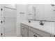 Bright bathroom features a double sink vanity with sleek, modern fixtures and a tiled shower-bath combination at 37785 W Santa Maria St, Maricopa, AZ 85138