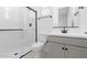 Modern bathroom featuring a glass-enclosed shower, sleek vanity, and contemporary black fixtures at 37785 W Santa Maria St, Maricopa, AZ 85138