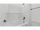 Modern bathroom showcasing stylish tile, black fixtures, and a shower-bath combination with a shower head at 37785 W Santa Maria St, Maricopa, AZ 85138