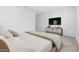 Bedroom featuring a comfortable bed with stylish decor and a modern console beneath a wall-mounted TV at 37785 W Santa Maria St, Maricopa, AZ 85138
