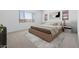 Bright bedroom featuring a large window, a neutral-toned bed, and an abstract art piece at 37785 W Santa Maria St, Maricopa, AZ 85138