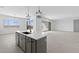 Modern kitchen island with sink, sleek countertops, and open layout connecting to the living space at 37785 W Santa Maria St, Maricopa, AZ 85138